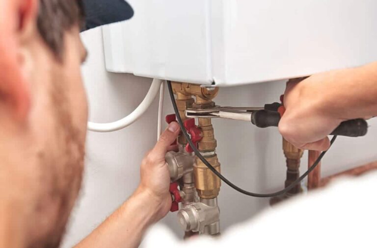 a worker conducting water heater maintenance tankless 01